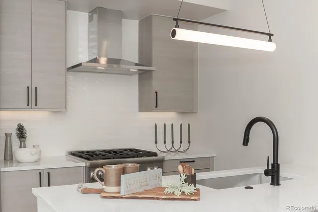 a kitchen with sink a stove and cabinets