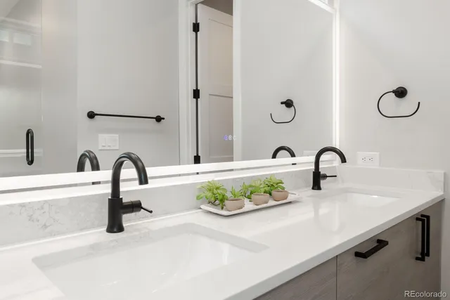 a bathroom with a granite countertop sink