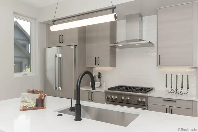 a kitchen with a refrigerator and a sink