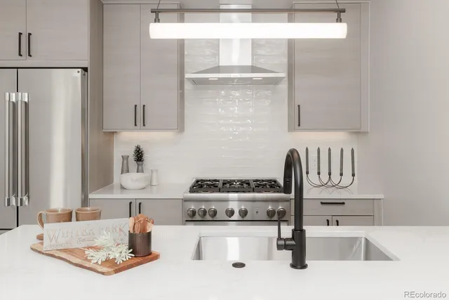 a kitchen with a refrigerator and a sink