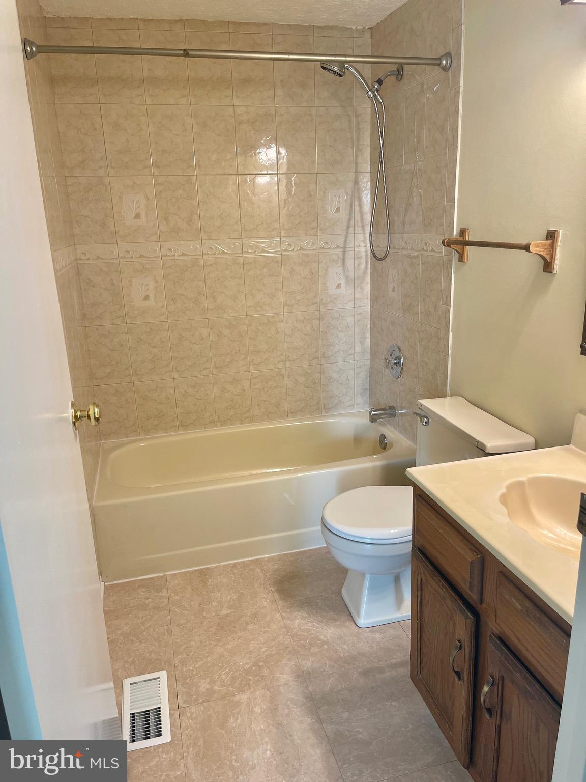 8604 Lawrence Hill Road Perry Hall, MD 21128 - Photo 18 of 38 a bathroom with a granite countertop bathtub shower sink vanity and toilet
