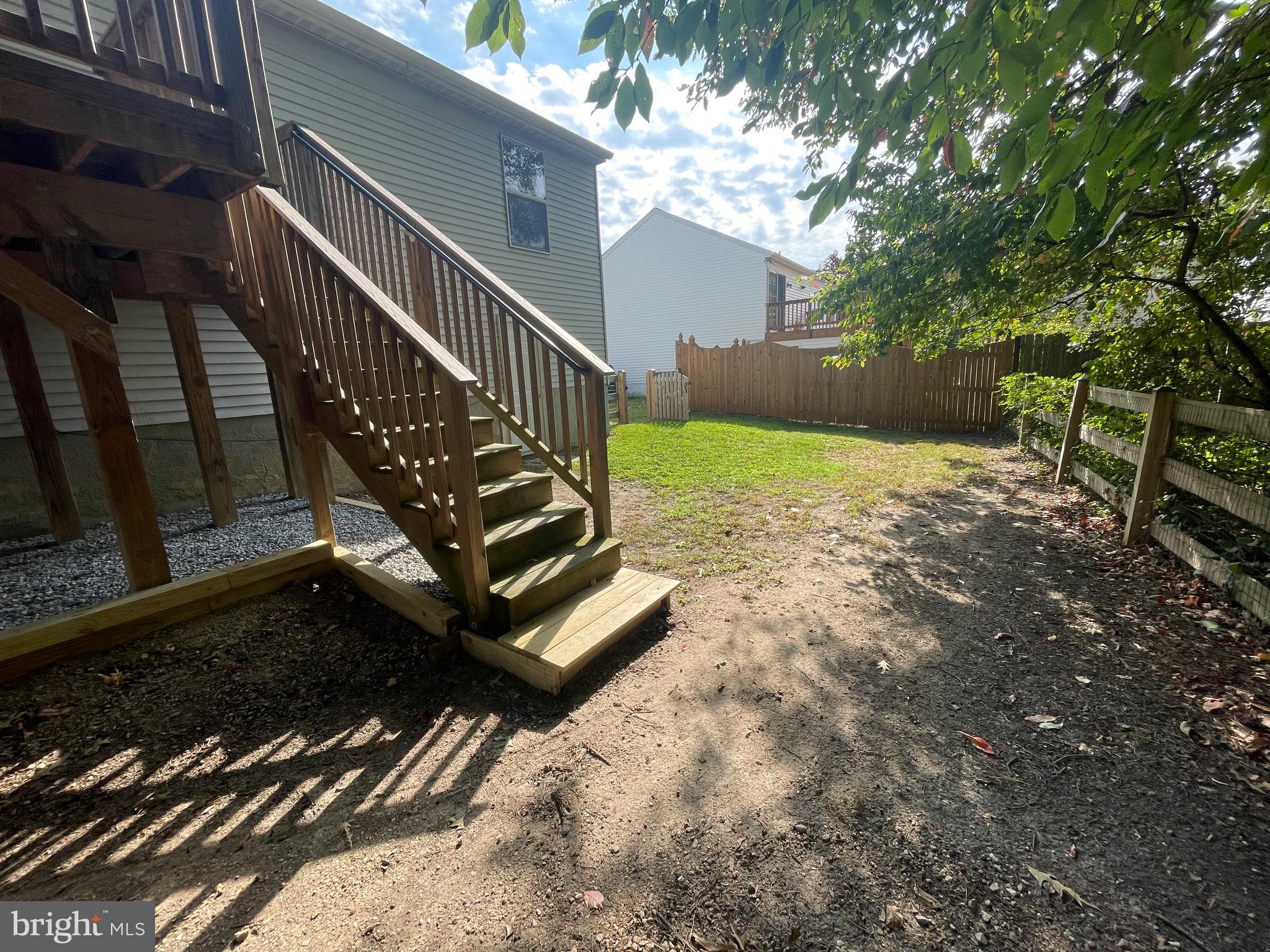8604 Lawrence Hill Road Perry Hall, MD 21128 - Photo 32 of 38 a view of a yard with wooden fence and a bench