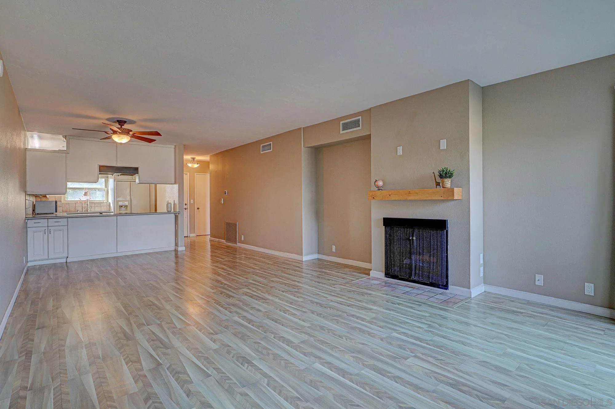 6385 Rancho Mission Road, Unit 6 San Diego, CA 92108 - Photo 9 of 26 a view of kitchen and empty room with wooden floor