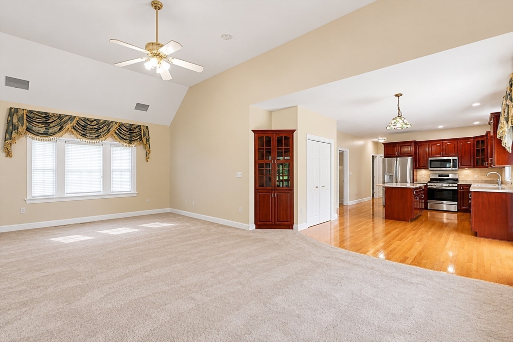 61 Indian Head Road Framingham, MA 01701 - Photo 37 of 42 a view of a livingroom with a chandelier fan and kitchen view