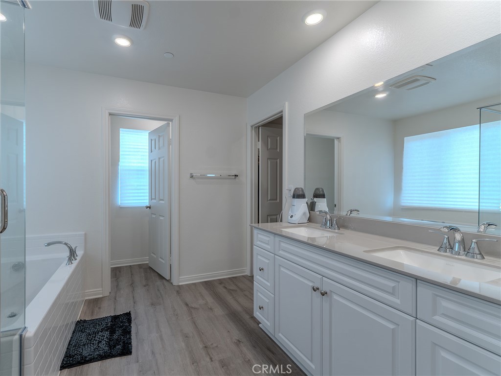 25602 Pne Rdg Road Homeland, CA 92548 - Photo 23 of 35 a spacious bathroom with a granite countertop sink a toilet a mirror and shower
