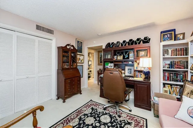 a room with furniture a bookshelf and a window