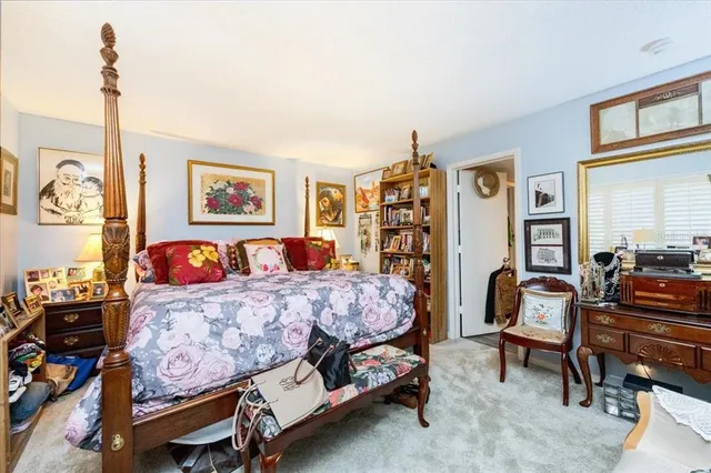 a bedroom with a bed window and couch