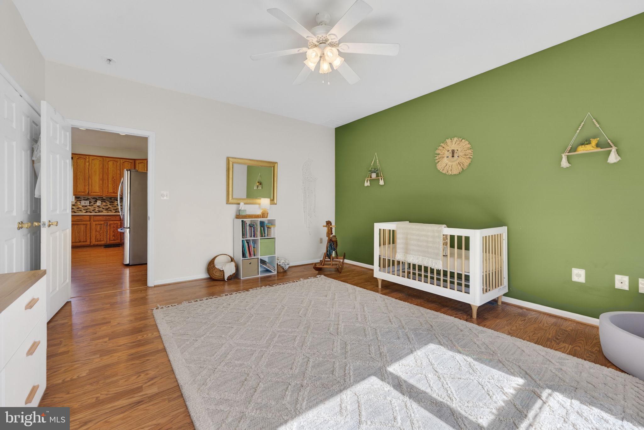 7453 Opal Road Warrenton, VA 20186 - Photo 13 of 53 a bedroom with a bed and wooden floor