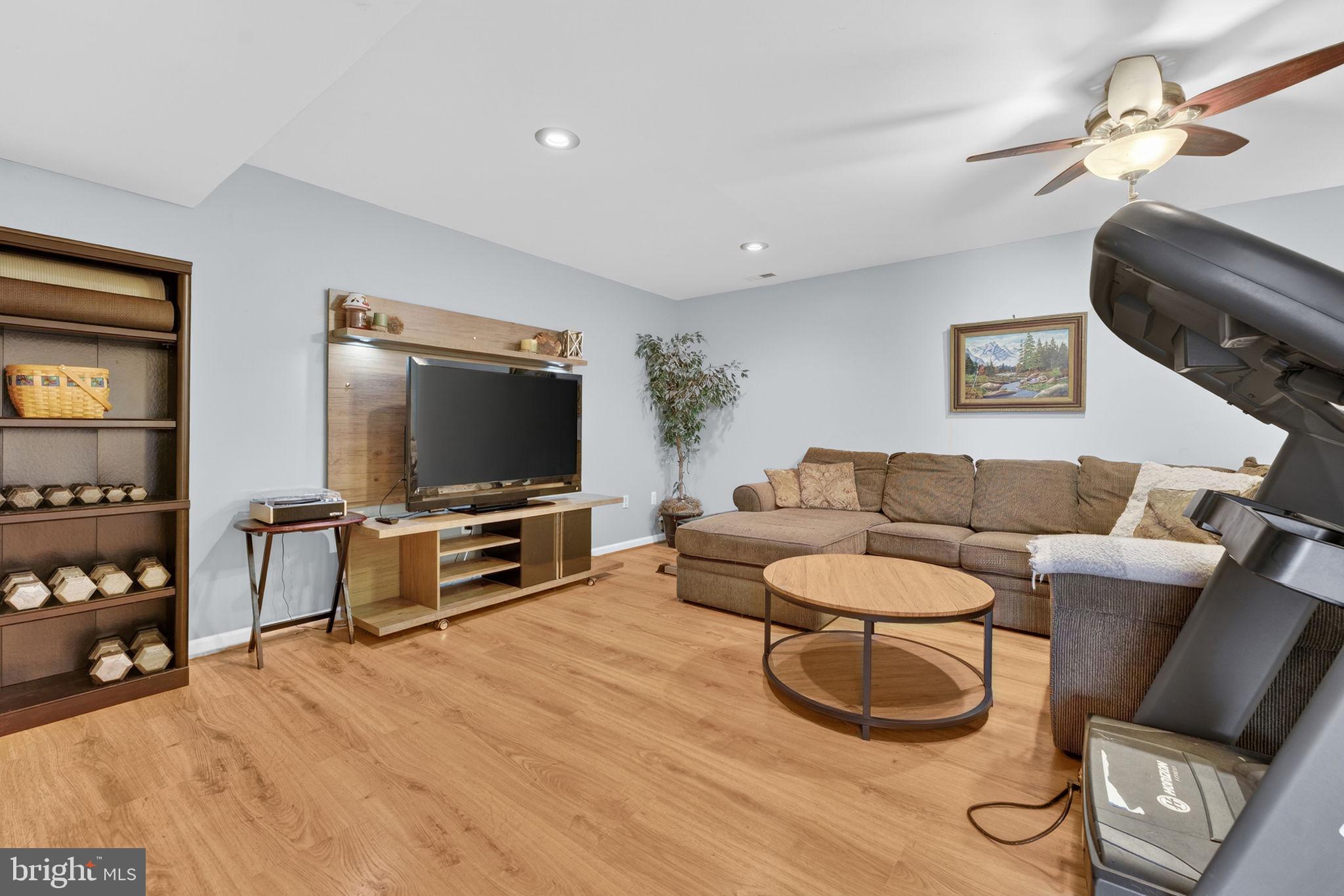 7453 Opal Road Warrenton, VA 20186 - Photo 19 of 53 a living room with furniture and a flat screen tv