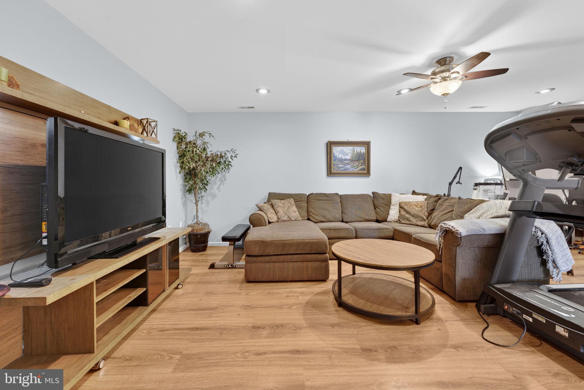 7453 Opal Road Warrenton, VA 20186 - Photo 20 of 53 a living room with furniture and a flat screen tv