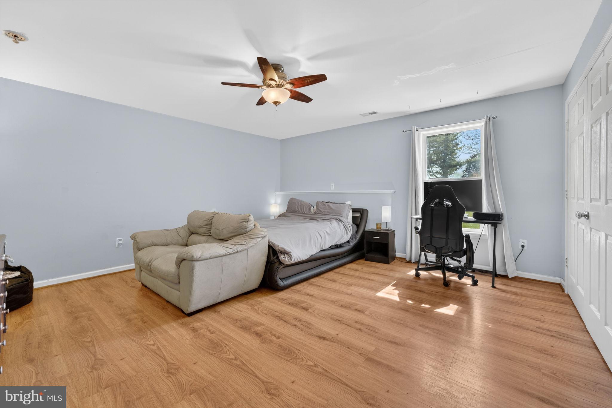7453 Opal Road Warrenton, VA 20186 - Photo 22 of 53 a living room with furniture and a wooden floor