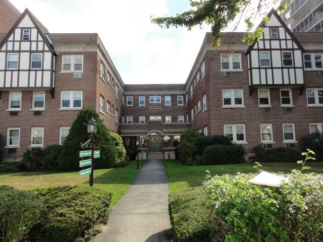 a front view of a residential apartment building with a yard