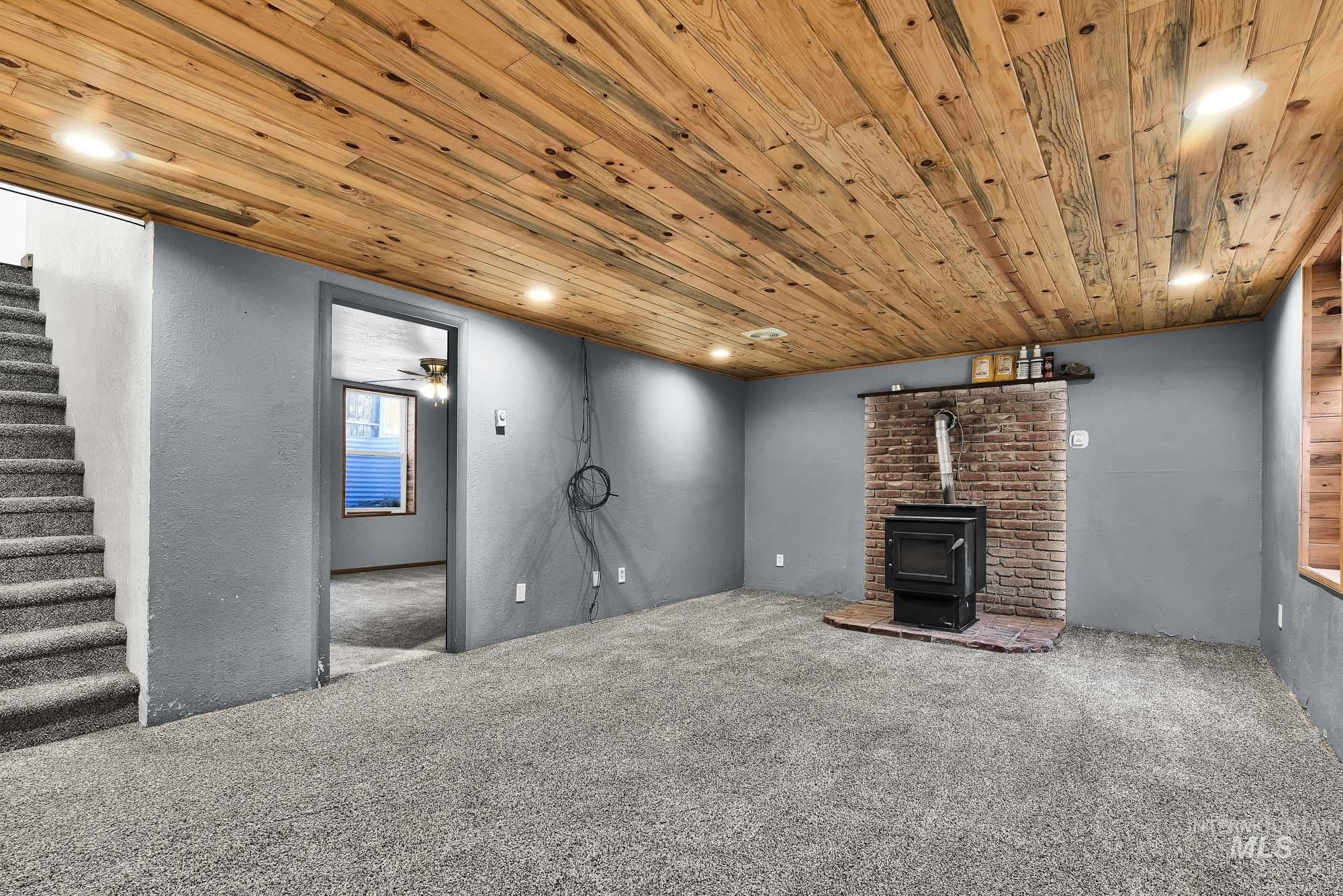 808 North A Street Parma, ID 83660 - Photo 15 of 29 Open living space featuring a wood plank ceiling, recessed lighting, and soft gray carpeting