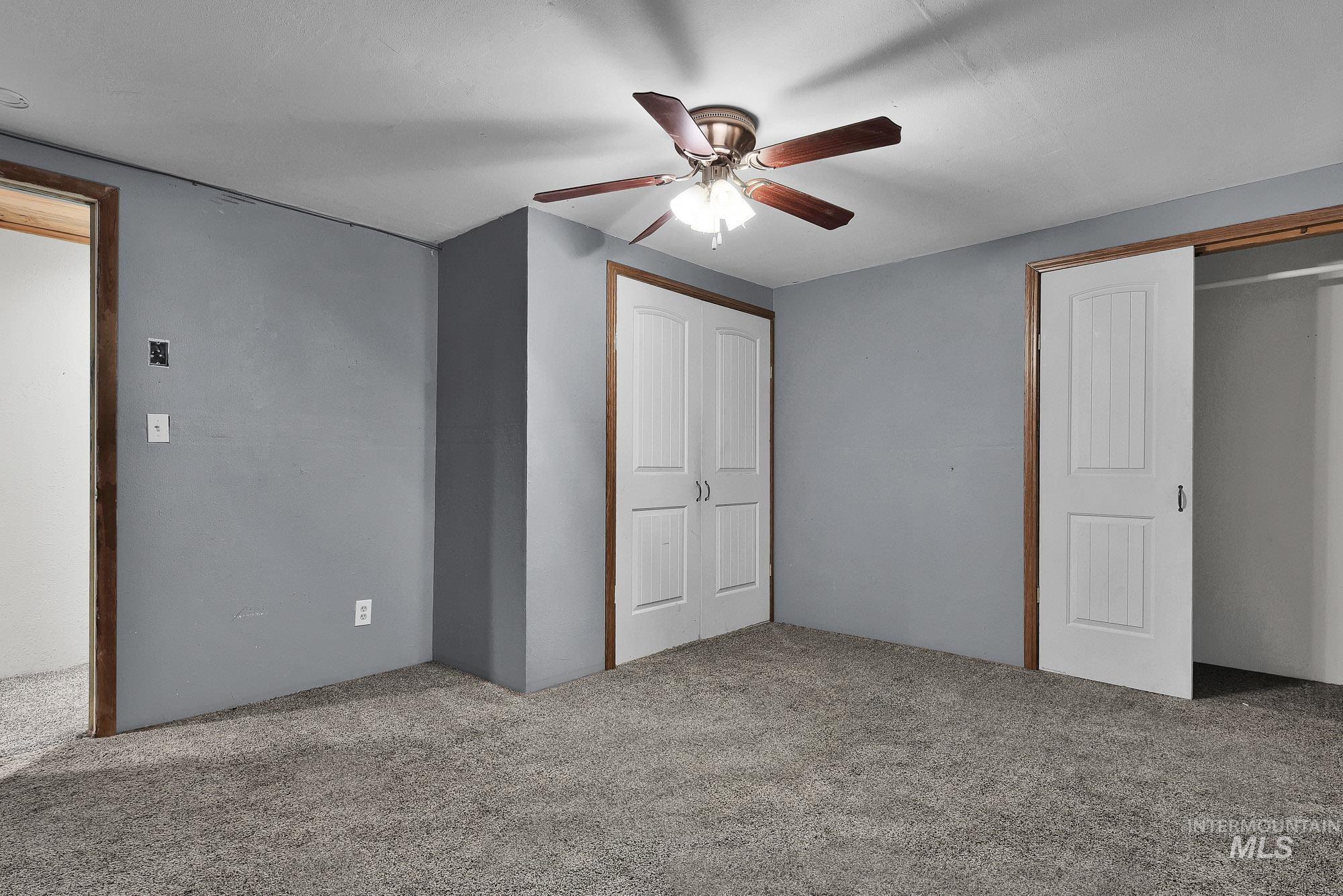 808 North A Street Parma, ID 83660 - Photo 21 of 29 Room featuring textured gray wall paint and gray carpet flooring