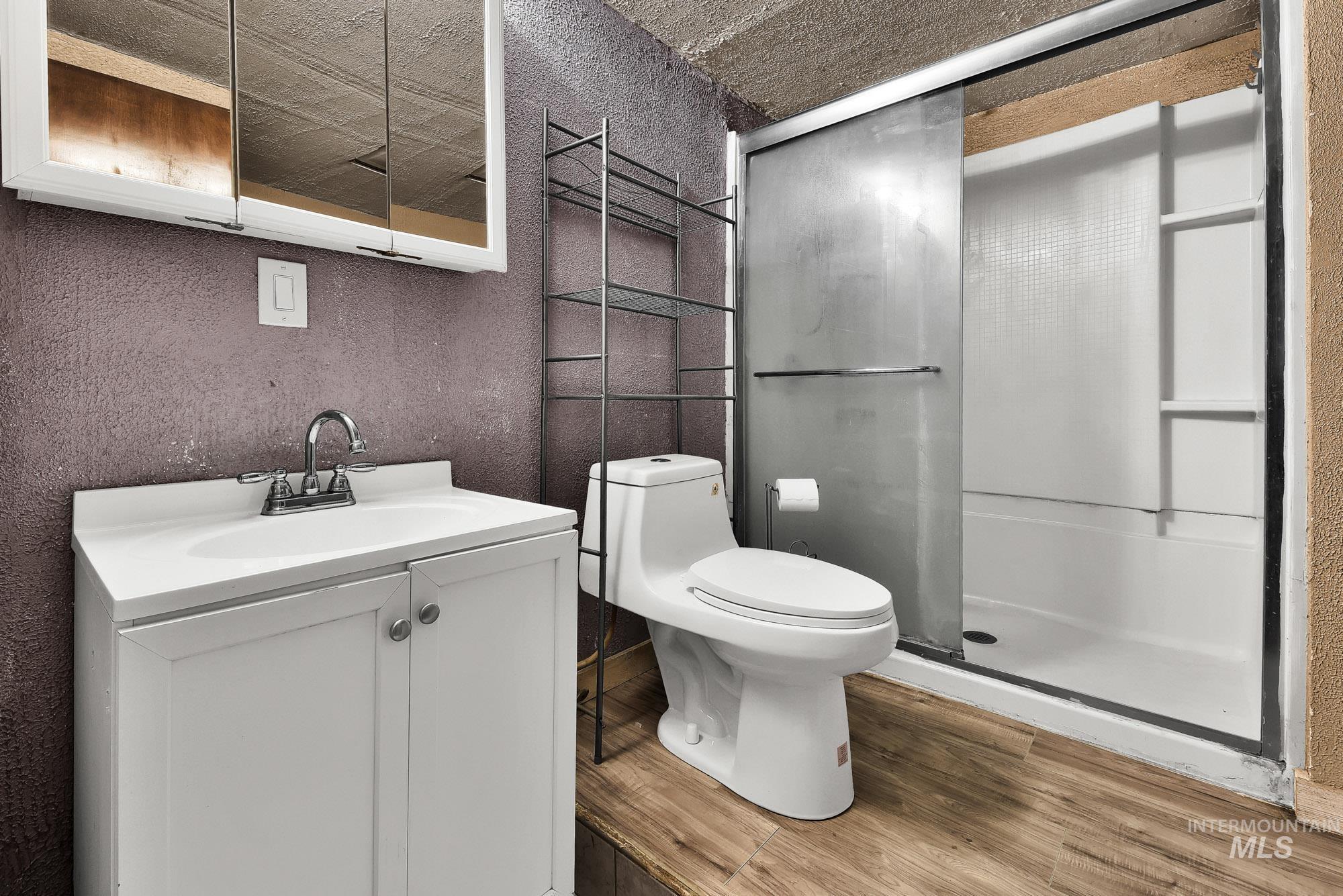 808 North A Street Parma, ID 83660 - Photo 22 of 29 Bathroom featuring a white vanity with integrated sink, chrome faucet, and a wall-mounted mirrored medicine cabinet
