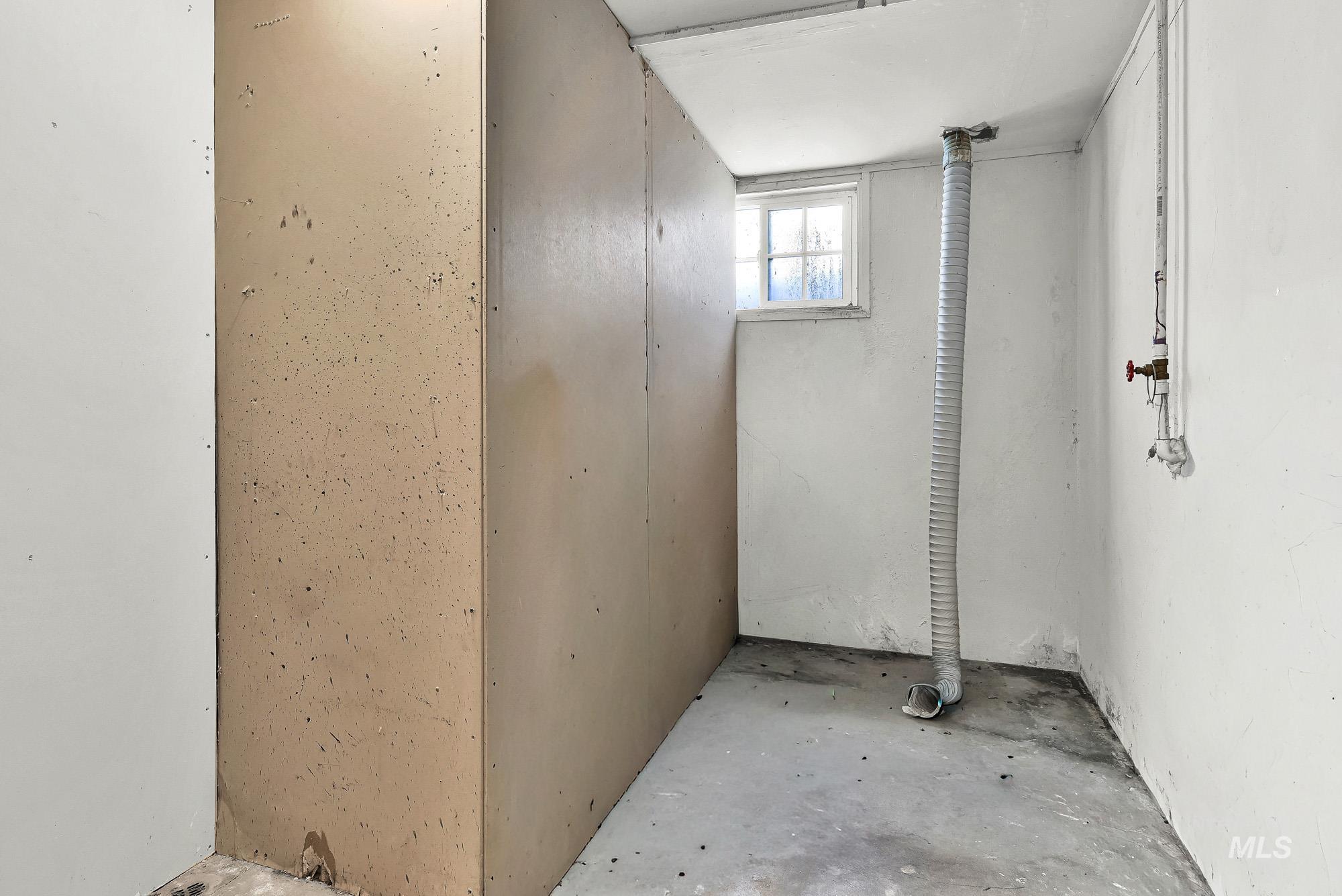808 North A Street Parma, ID 83660 - Photo 24 of 29 Concrete flooring with a single window and exposed utility piping