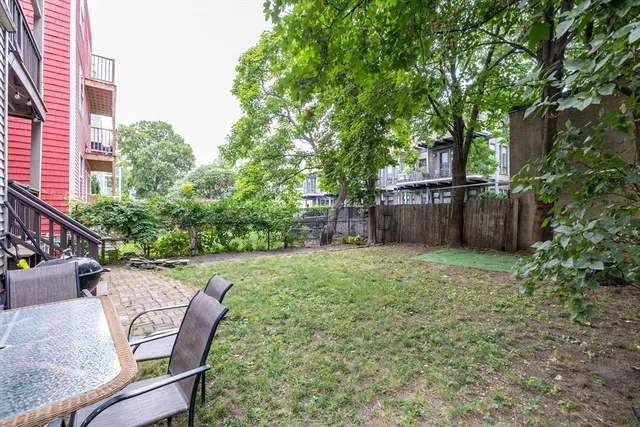 a view of a backyard with furniture and a garden
