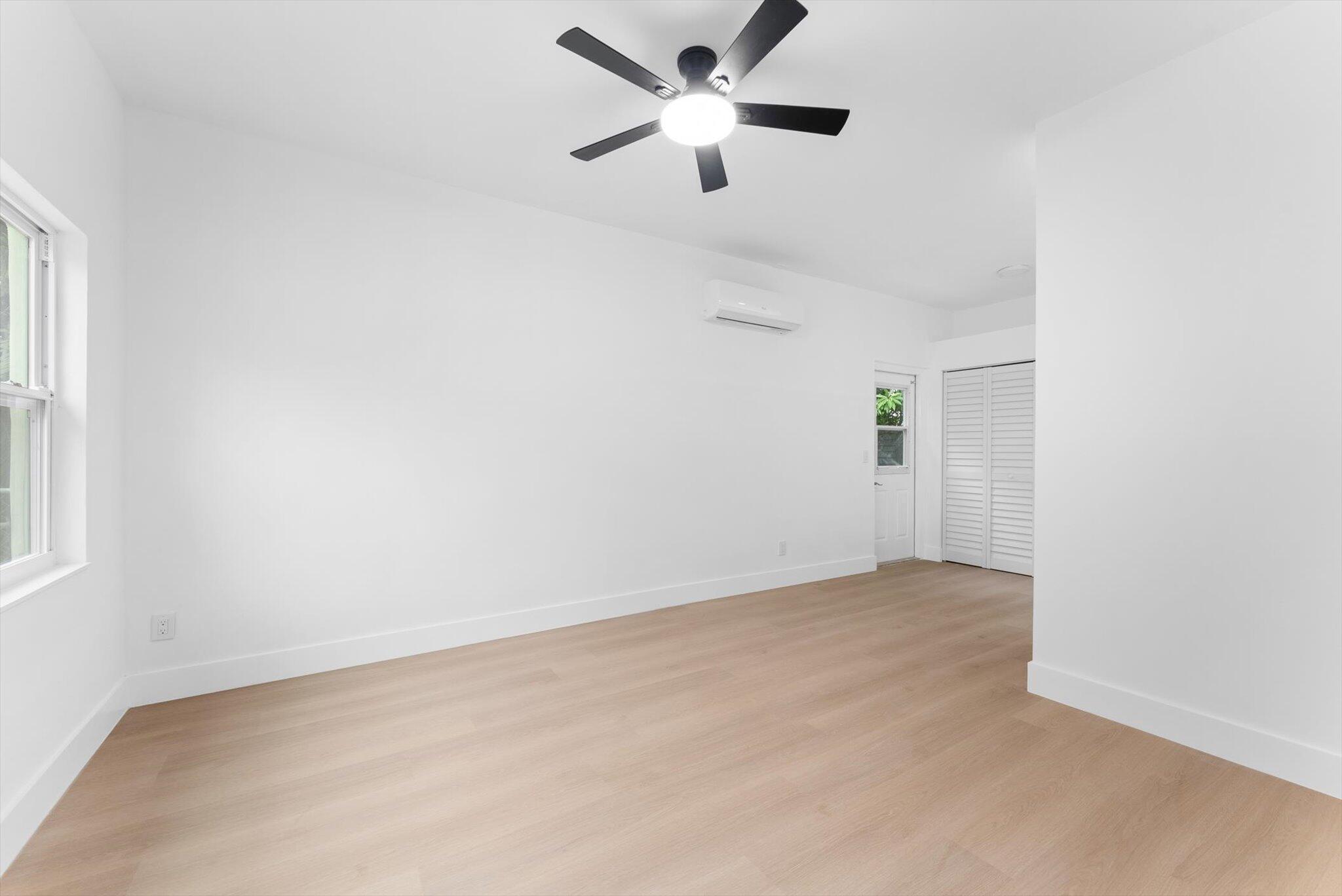 1891 Ridge Road North Palm Beach, FL 33408 - Photo 12 of 24 an empty room with ceiling fan and window
