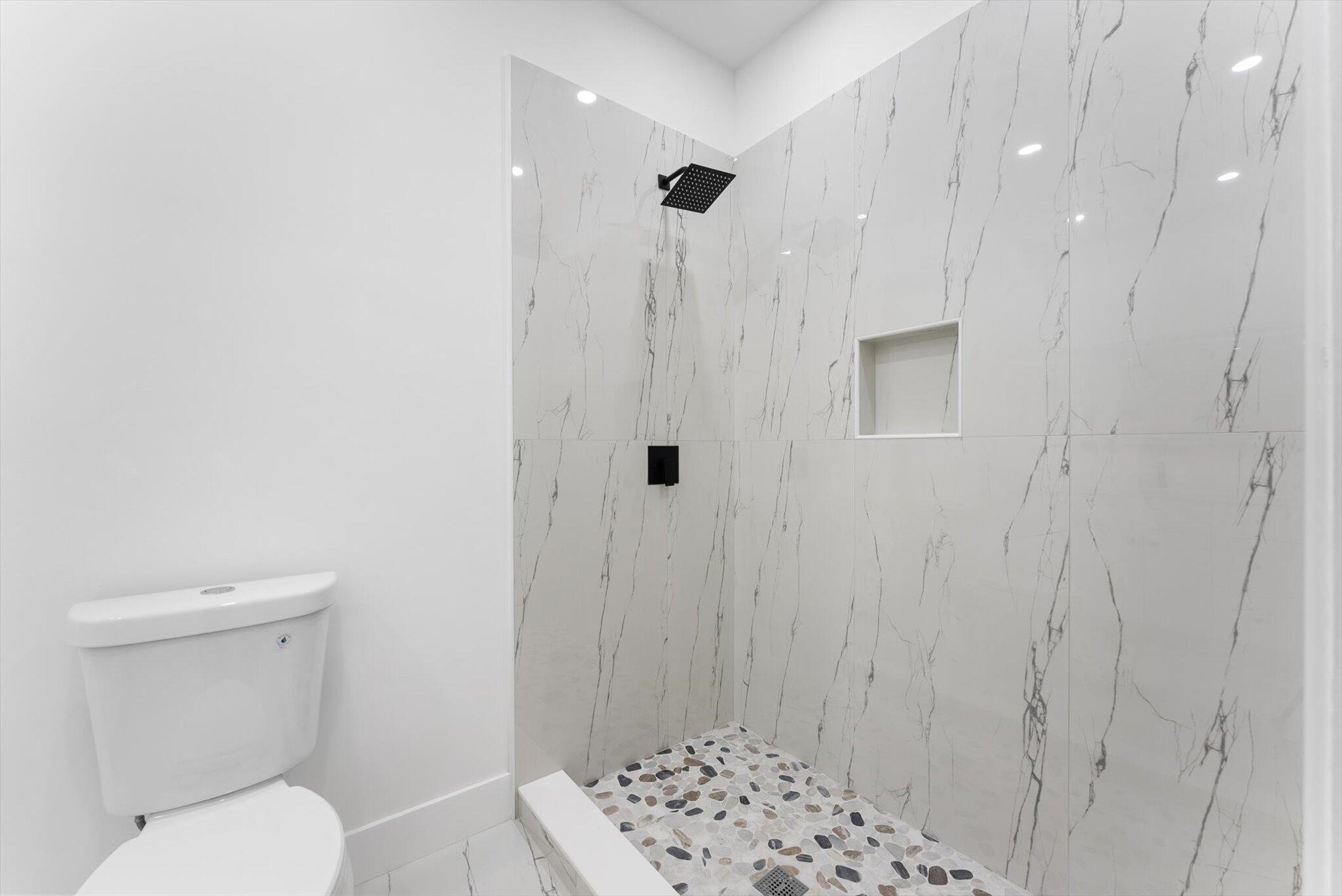 1891 Ridge Road North Palm Beach, FL 33408 - Photo 16 of 24 a bathroom with a toilet a shower and a sink