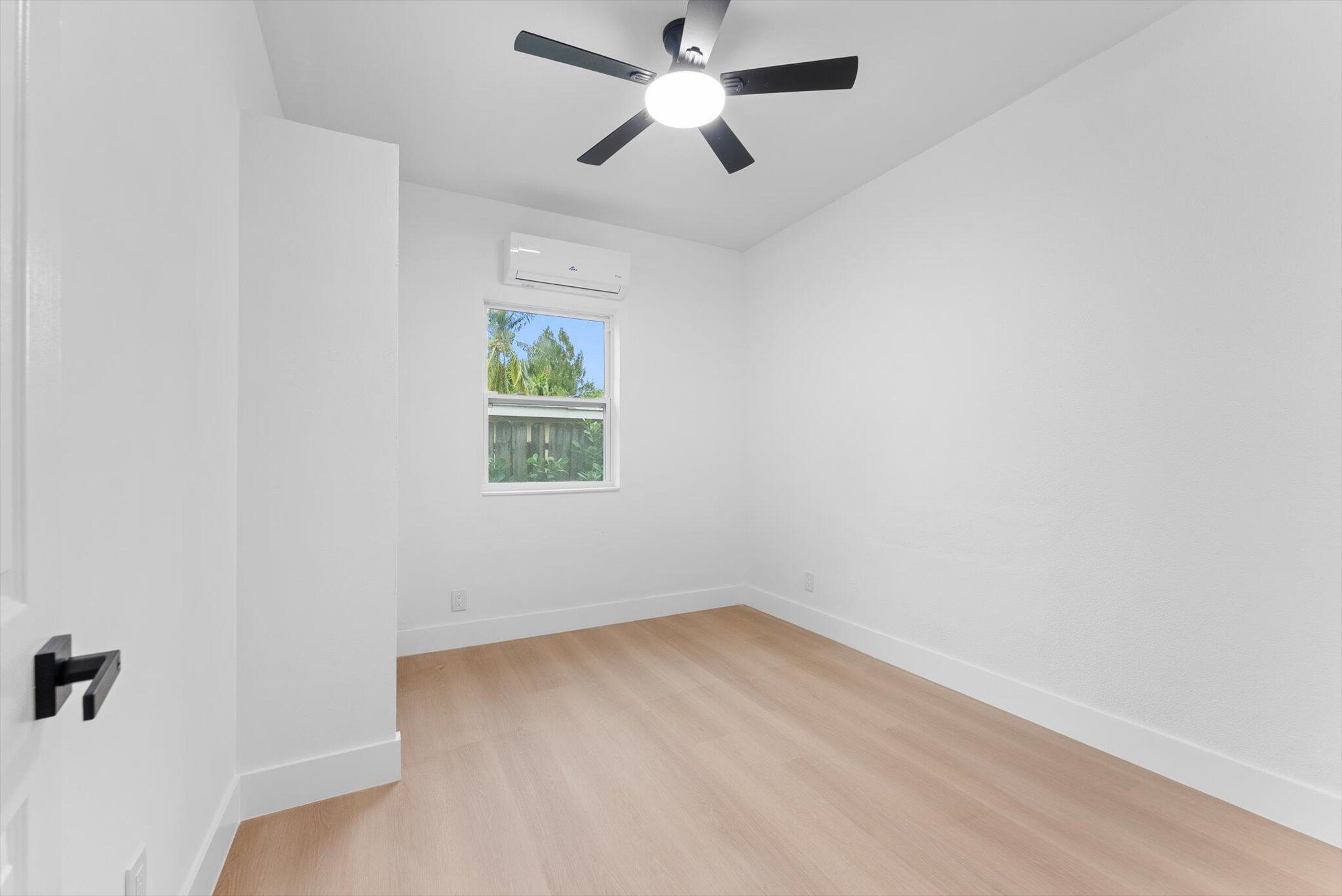1891 Ridge Road North Palm Beach, FL 33408 - Photo 17 of 24 an empty room with a window and a fan