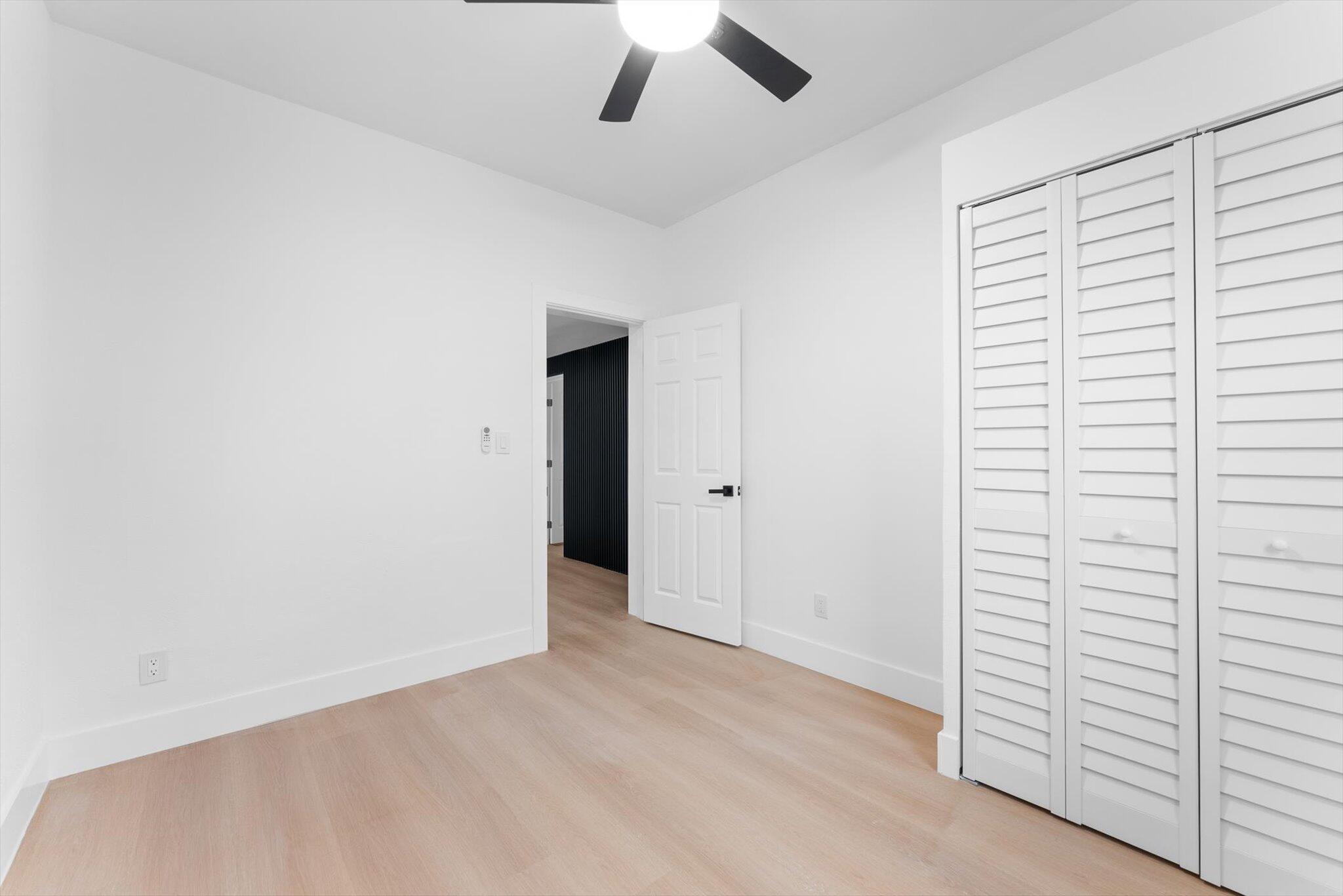 1891 Ridge Road North Palm Beach, FL 33408 - Photo 18 of 24 an empty room with a ceiling fan and window