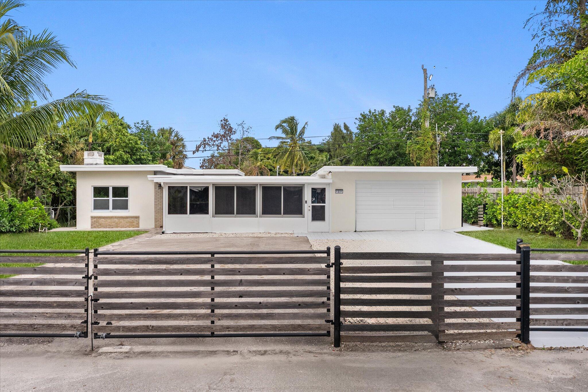 1891 Ridge Road North Palm Beach, FL 33408 - Photo 23 of 24 a view of a white house with a yard
