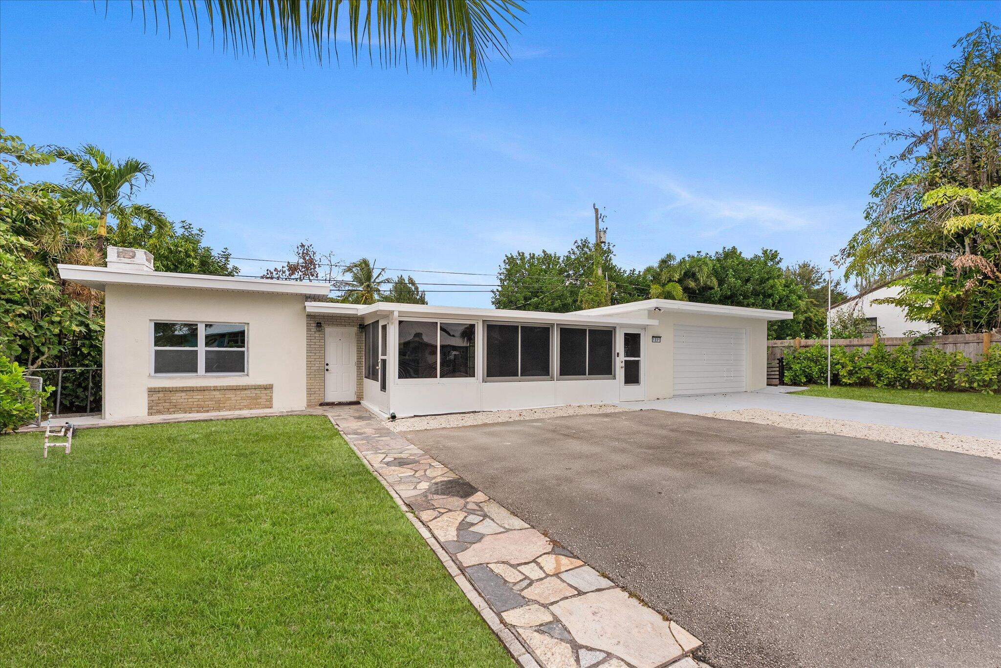 1891 Ridge Road North Palm Beach, FL 33408 - Photo 24 of 24 a front view of a house with a garden