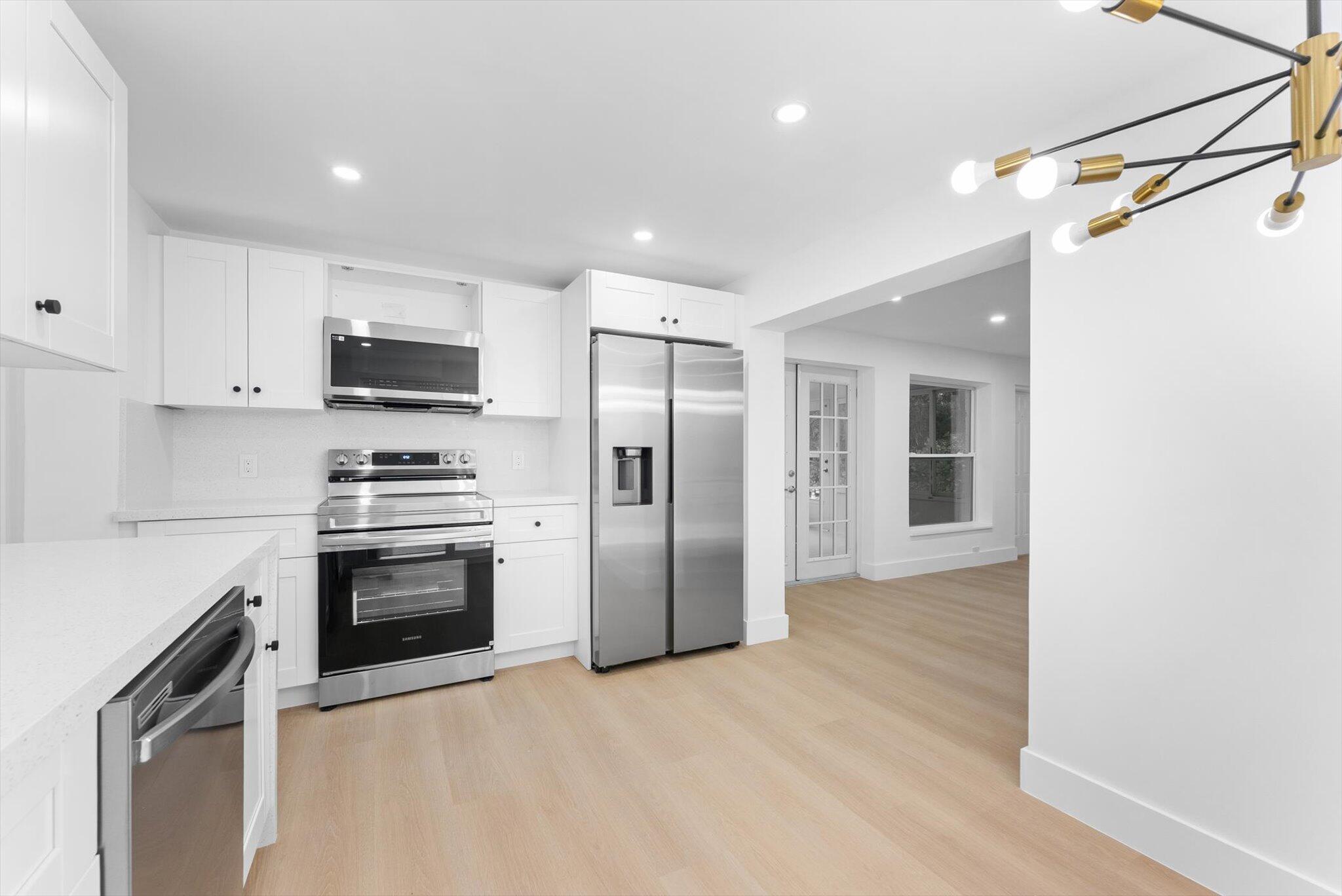 1891 Ridge Road North Palm Beach, FL 33408 - Photo 6 of 24 a kitchen with stainless steel appliances a refrigerator stove and microwave