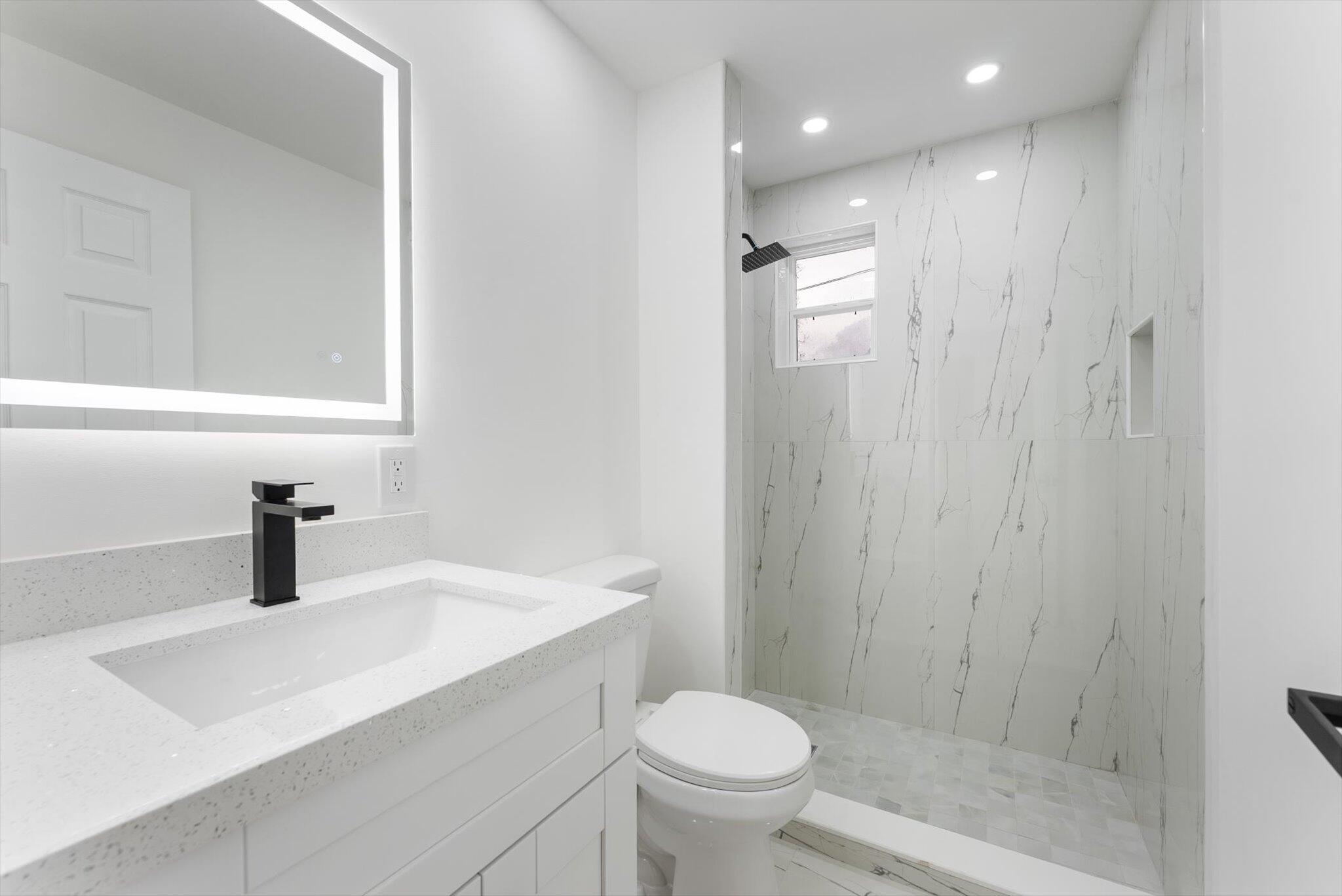 1891 Ridge Road North Palm Beach, FL 33408 - Photo 9 of 24 a bathroom with a sink a toilet and shower