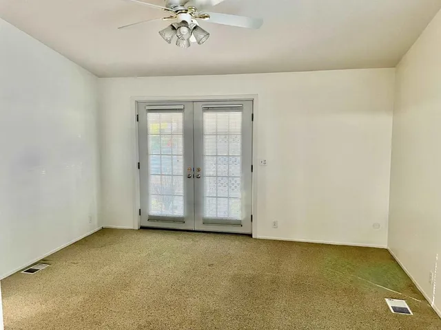 an empty room with a empty space and windows