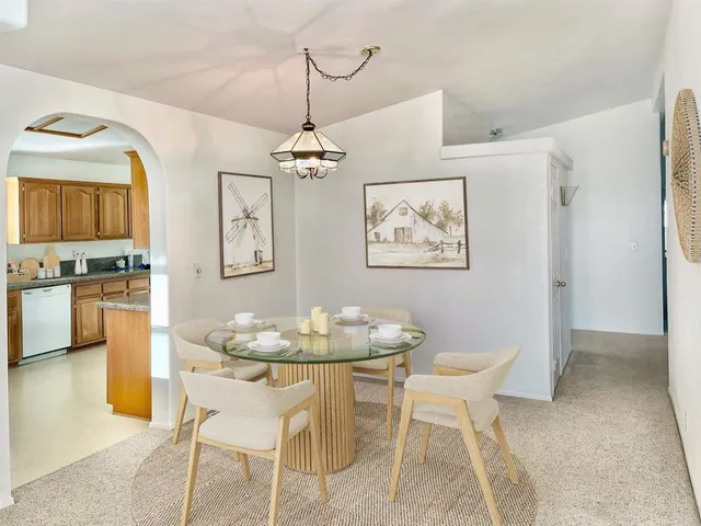 a dining room with furniture and chandelier
