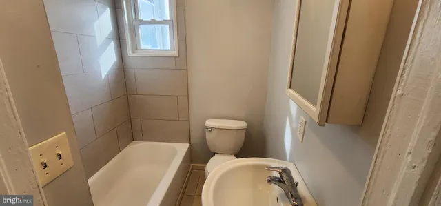a bathroom with a toilet and a sink