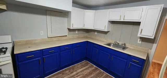 a kitchen with stainless steel appliances granite countertop wooden cabinets and sink
