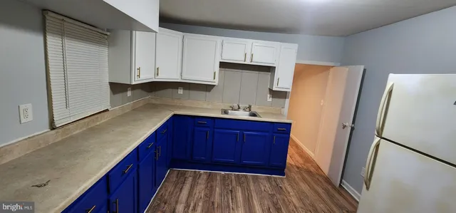 a kitchen with wooden cabinets and refrigerator