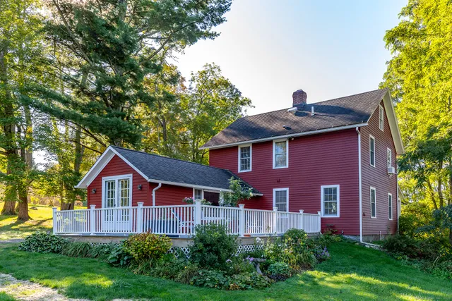 a red brick house with trees in front of it