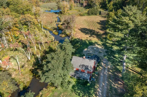 an aerial view of a house with a yard