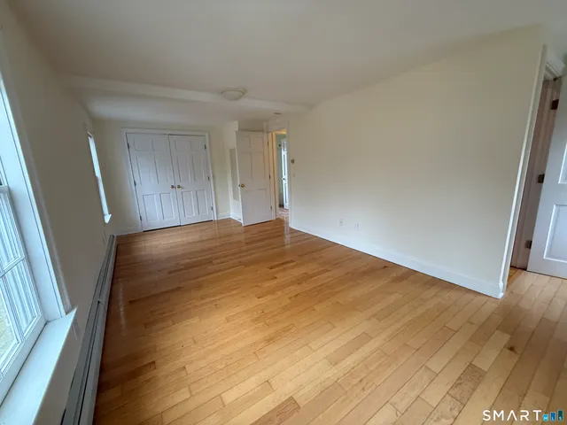 a view of an empty room and wooden floor
