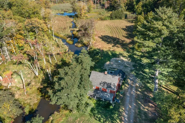 an aerial view of a house with a yard