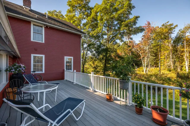 a view of a chairs and table in the balcony