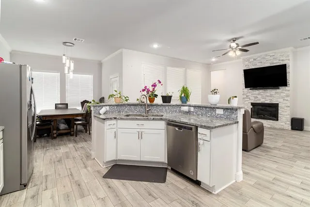 a kitchen with a sink and a stove top oven