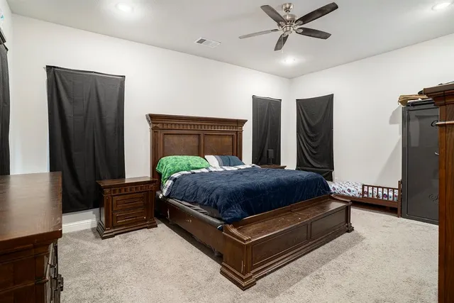 a bedroom with a bed dresser and a window
