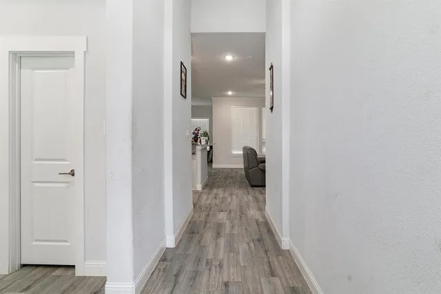 a view of a room with wooden floor
