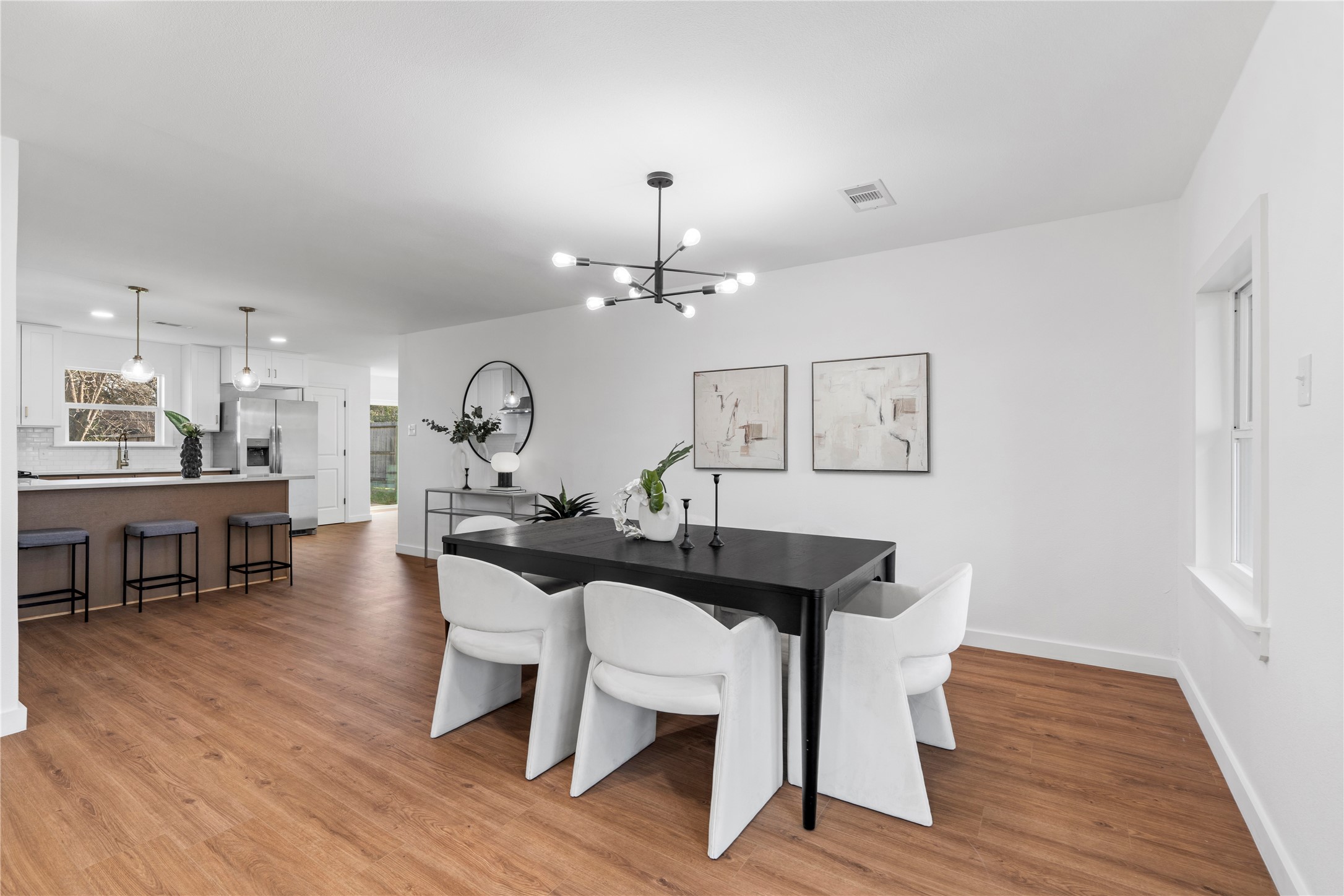 5023 Redstart Street Houston, TX 77035 - Photo 9 of 34 The modern dining space flows directly into the gourmet kitchen, ensuring the chef is always part of the conversation.