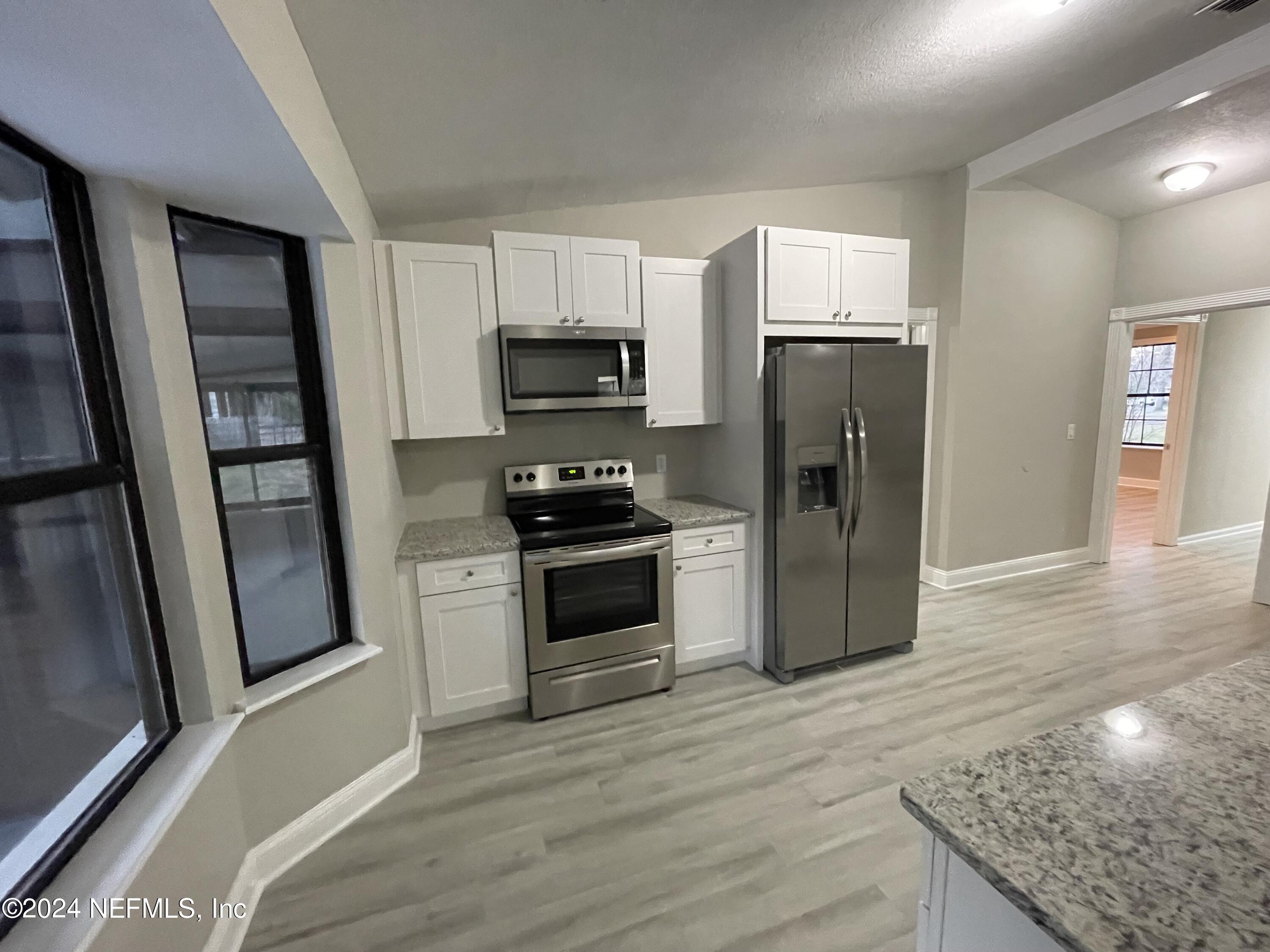 4535 Chipmunk Road Middleburg, FL 32068 - Photo 12 of 26 a kitchen with stainless steel appliances granite countertop a refrigerator stove and sink