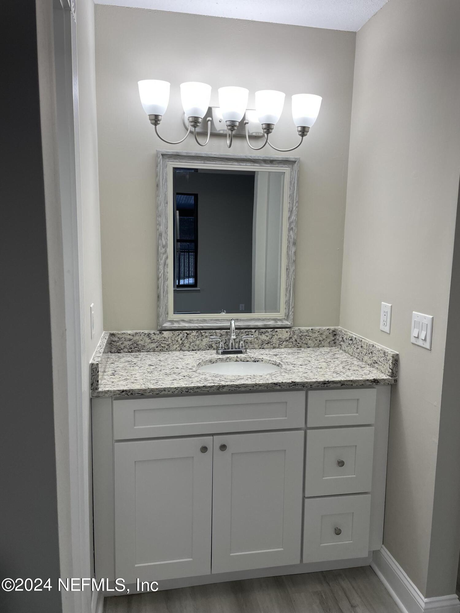 4535 Chipmunk Road Middleburg, FL 32068 - Photo 14 of 26 a bathroom with a granite countertop sink and a mirror