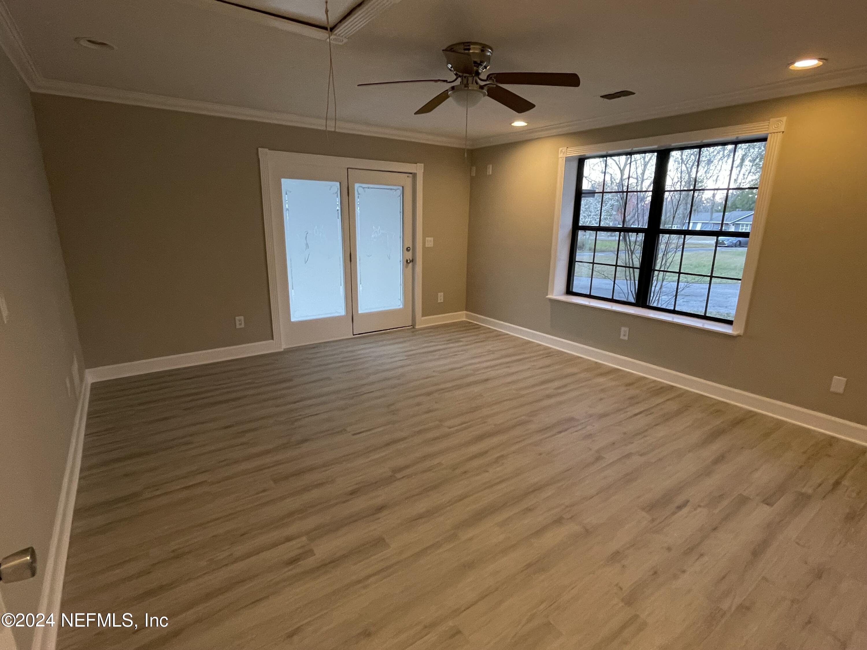 4535 Chipmunk Road Middleburg, FL 32068 - Photo 16 of 26 a view of an empty room with a window and wooden floor