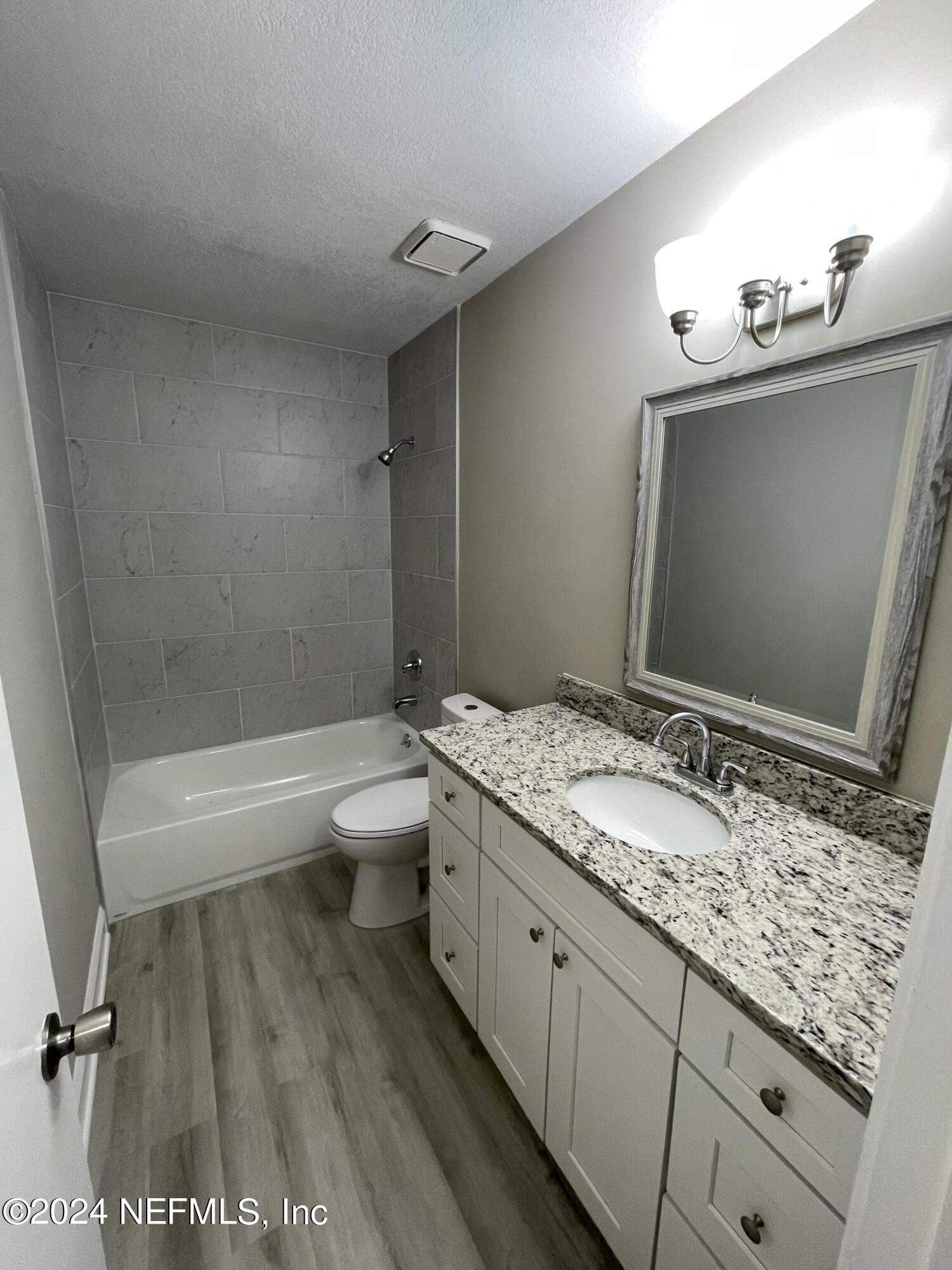4535 Chipmunk Road Middleburg, FL 32068 - Photo 20 of 26 a bathroom with a granite countertop sink toilet and shower