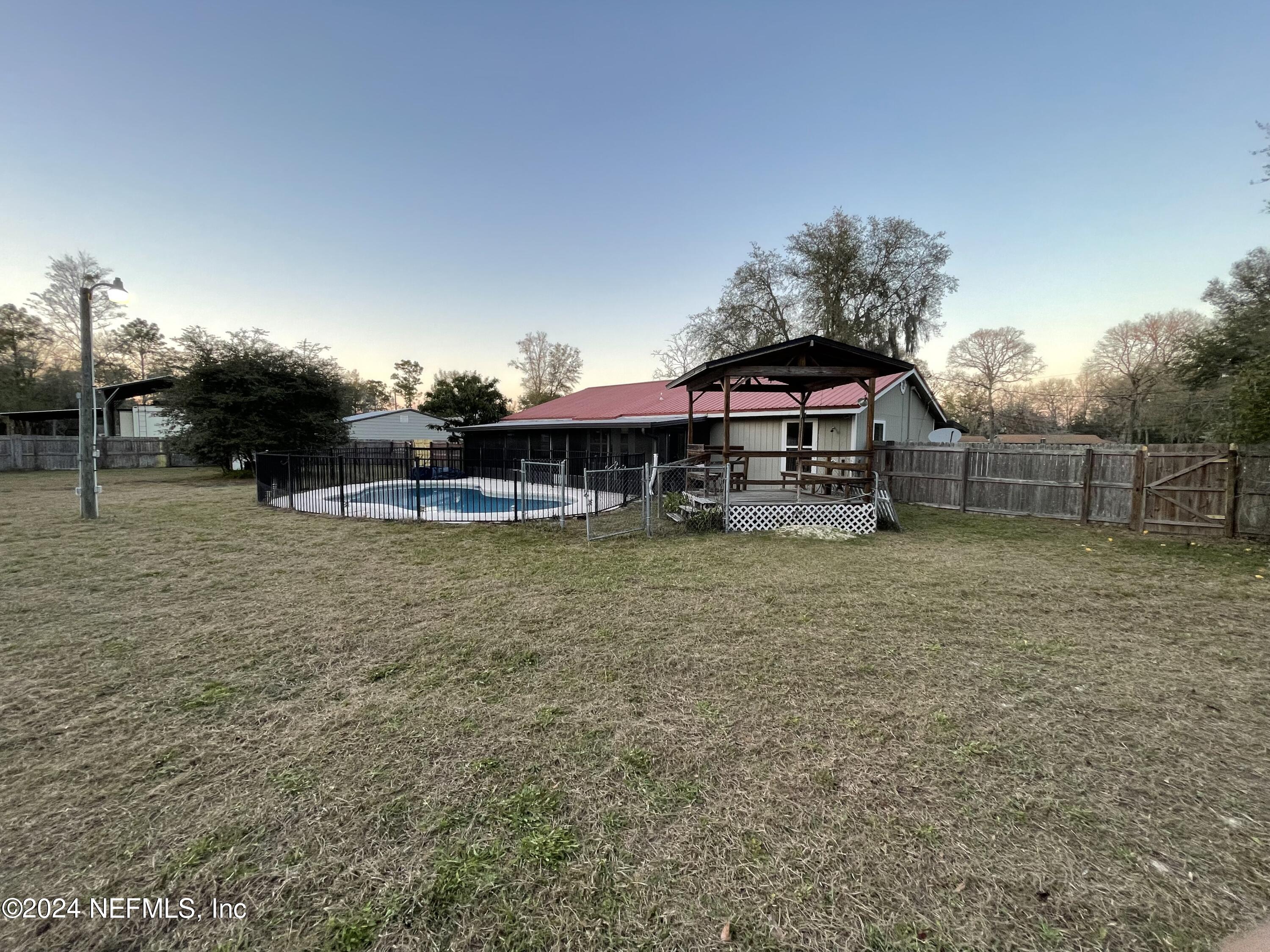 4535 Chipmunk Road Middleburg, FL 32068 - Photo 24 of 26 a backyard of a house with table and chairs