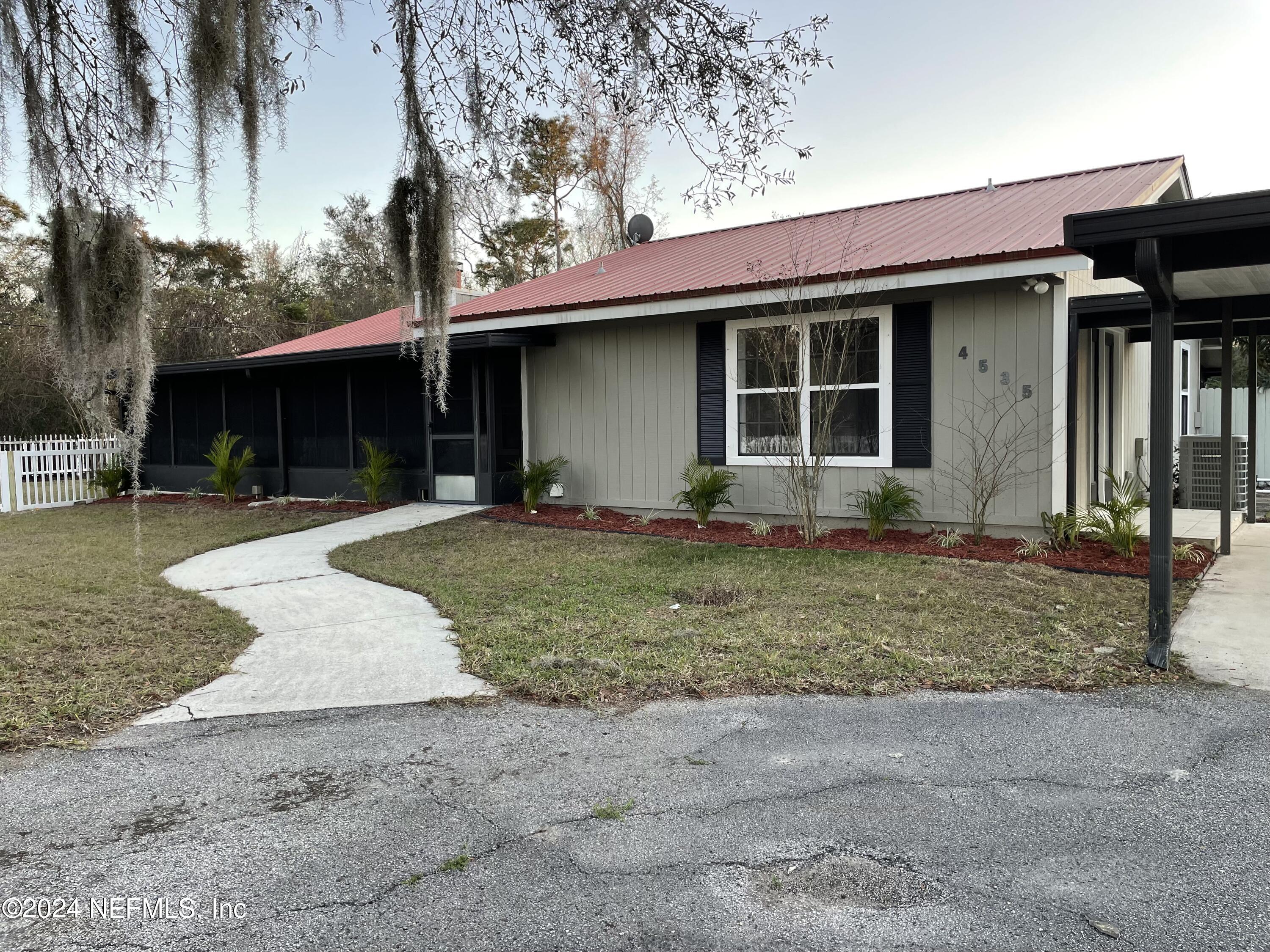 4535 Chipmunk Road Middleburg, FL 32068 - Photo 5 of 26 a front view of a house with garden