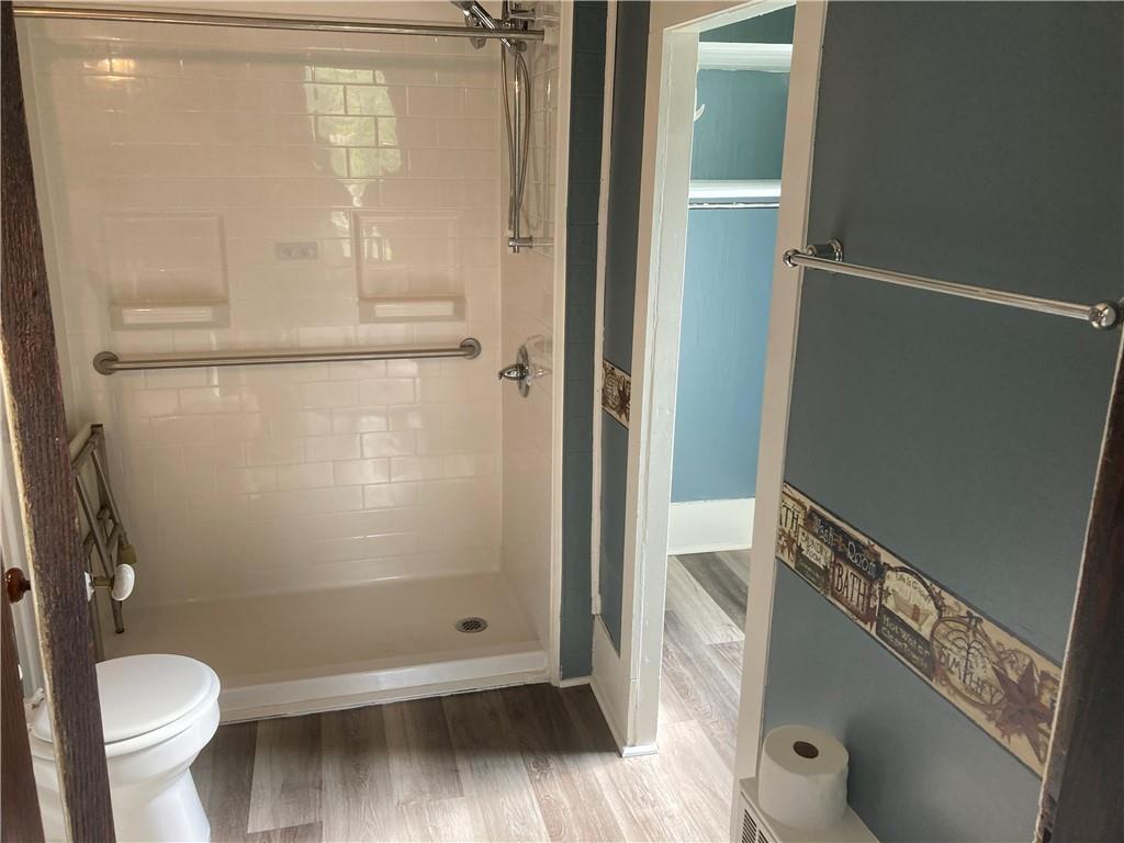 12 Lake Road Hadley, PA 16130 - Photo 7 of 10 a bathroom with a granite countertop shower and a toilet
